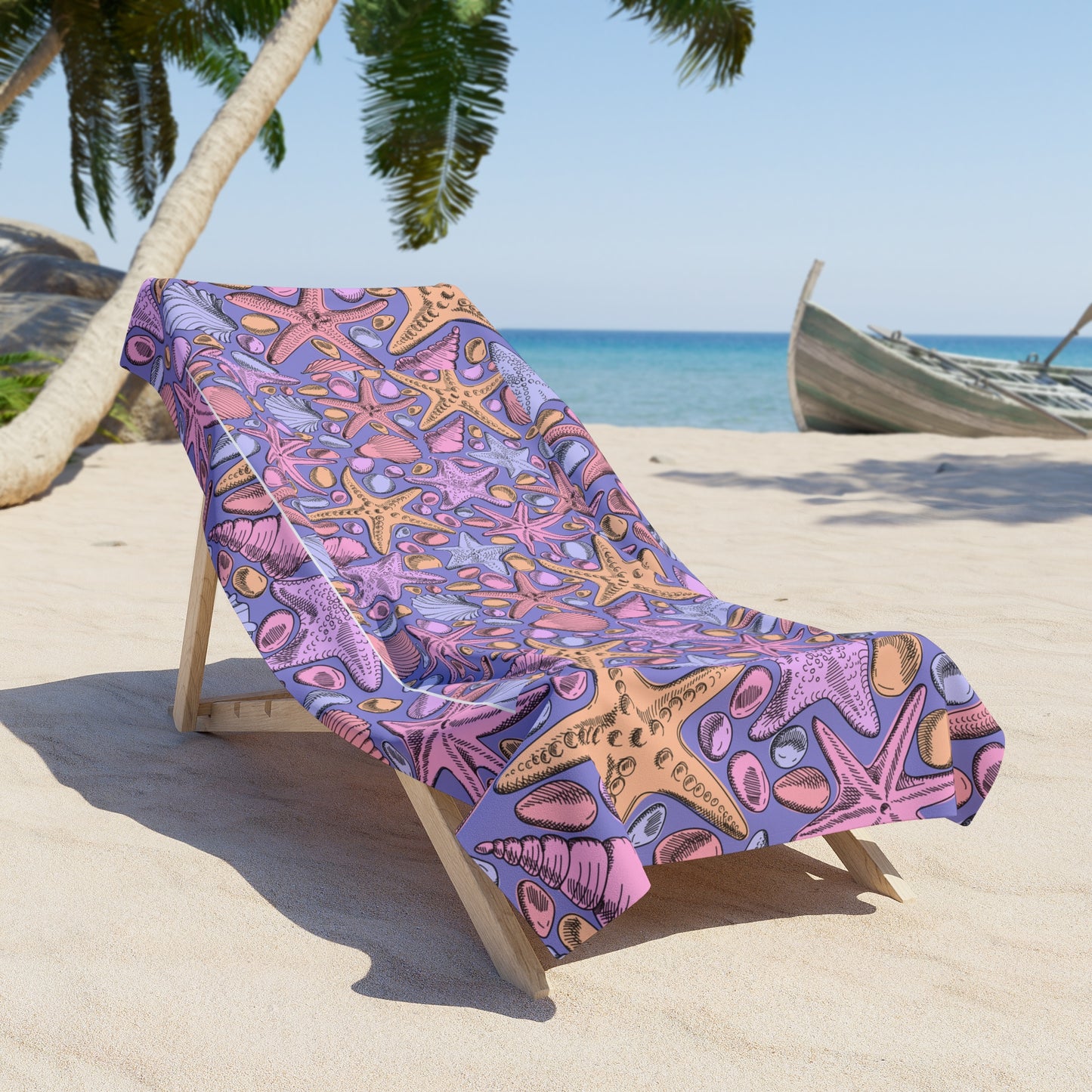 Colorful beach towel with starfish pattern on a lounge chair at the beach.