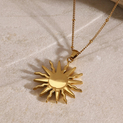 Elegant gold necklace with solar rays and gemstone detailing