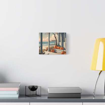 Canvas print of a beach scene with pumpkins on a wall above a desk.
