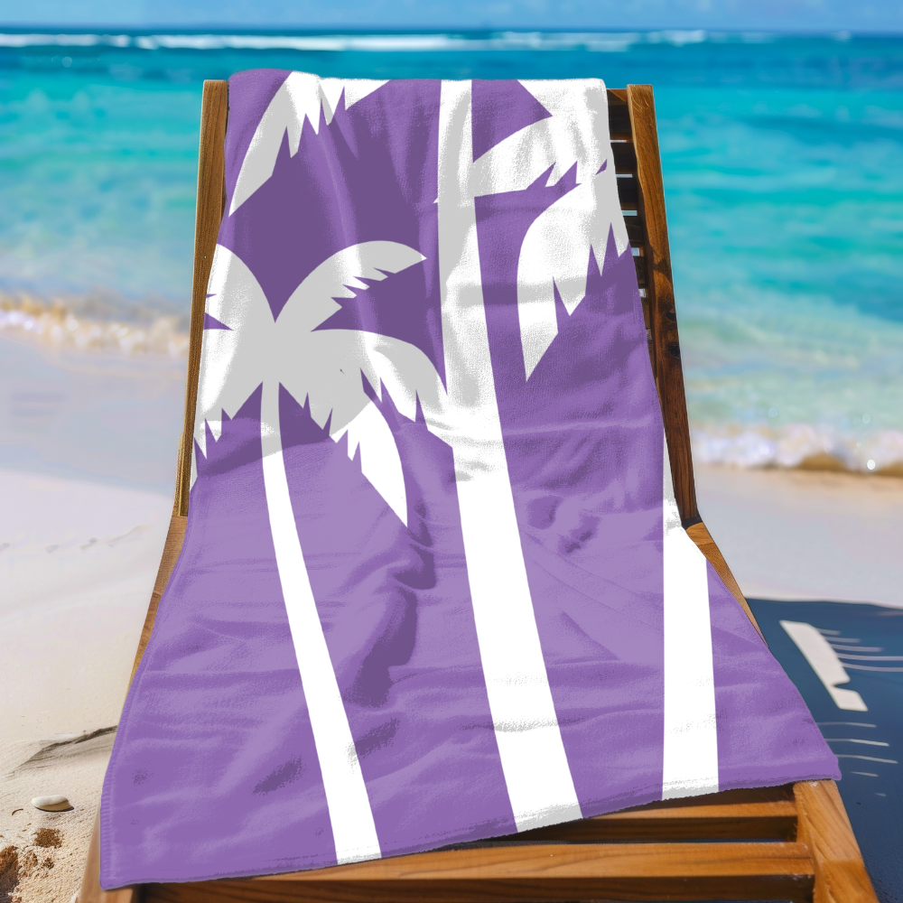 Purple beach towel with white palm tree design on a wooden chair at the beach.