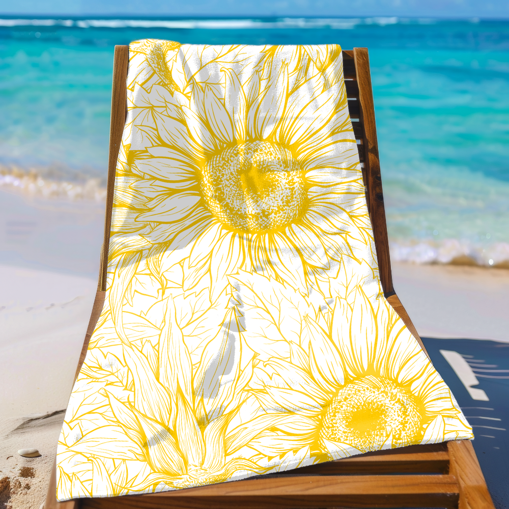Beach chair with a yellow sunflower patterned towel on a sandy beach with ocean in the background