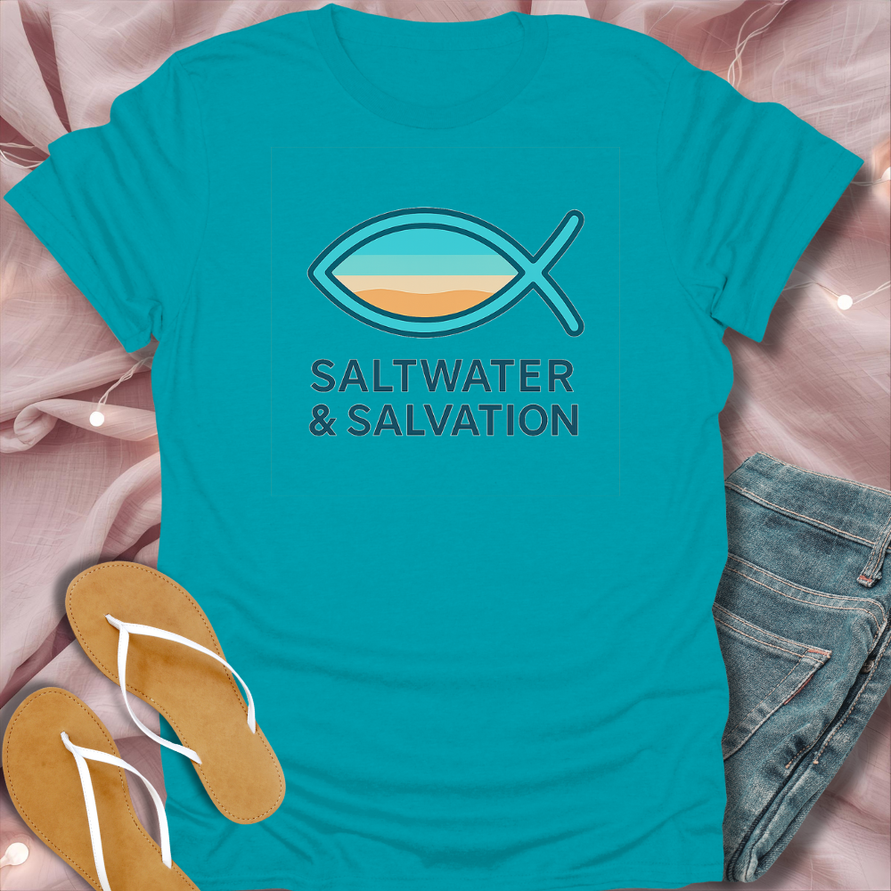 Blue t-shirt with 'Saltwater & Salvation' design on a pink fabric background