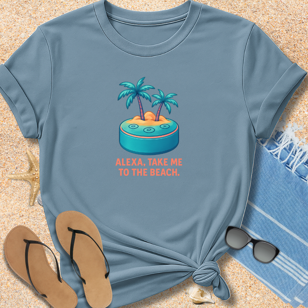 Blue t-shirt with beach graphic and text on sand with flip-flops and towel.