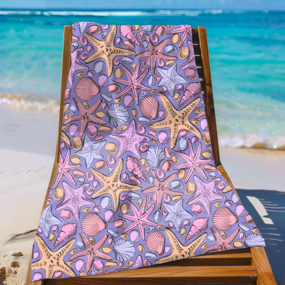 Beach towel with starfish and shell pattern on a wooden chair at the beach.