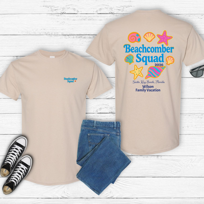 Beige t-shirt with 'Beachcomber Squad' design, jeans, and sneakers on a wooden surface