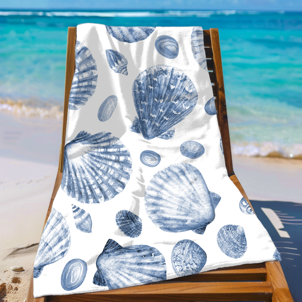 Beach towel with blue shell pattern on a wooden chair by the ocean.