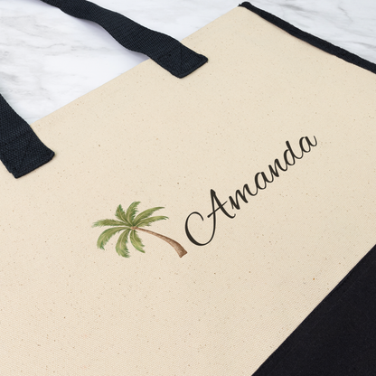 Beige tote bag with palm tree design and 'Amanda' text on a white background