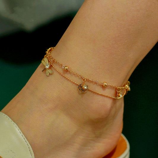 Double-layer anklet with dragonfly and floral charms in gold tone
