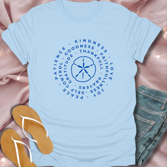 Light blue t-shirt with motivational text design on a pink fabric background