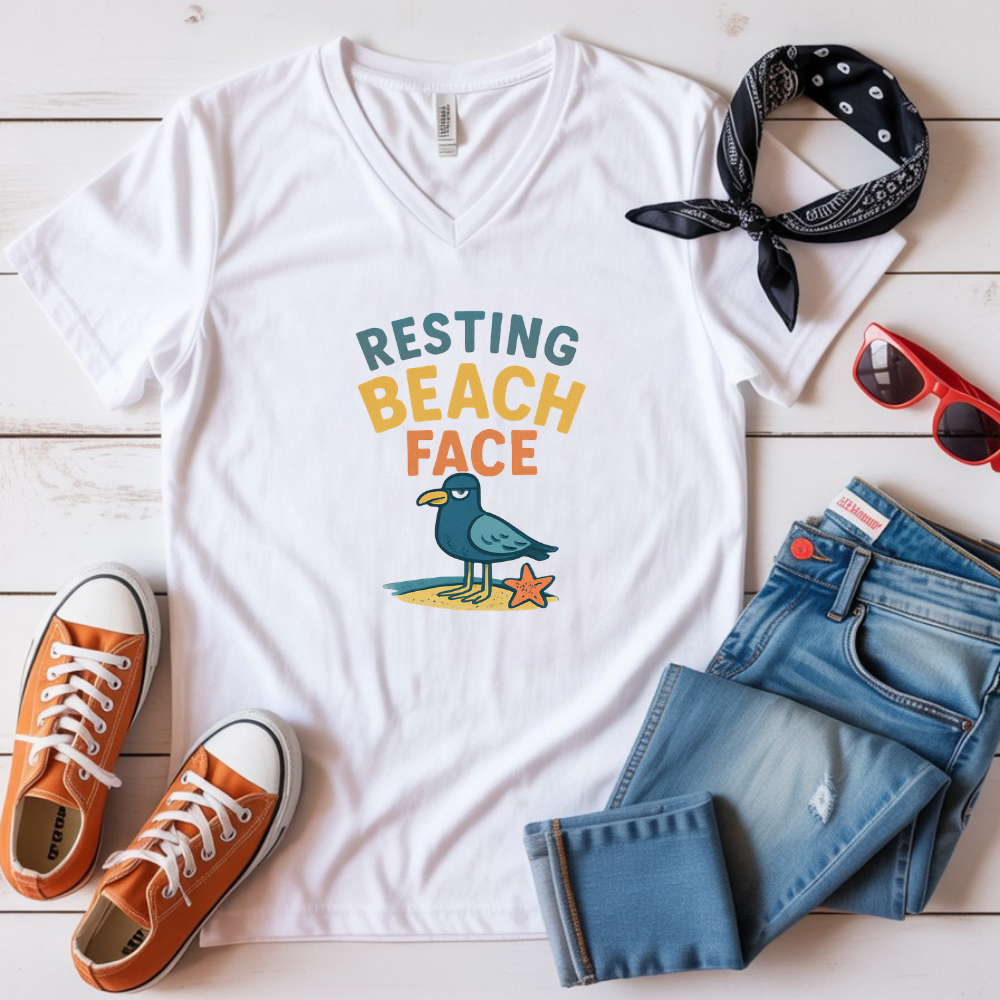 White t-shirt with 'Resting Beach Face' design, orange sneakers, blue jeans, and a bandana on a wooden surface.