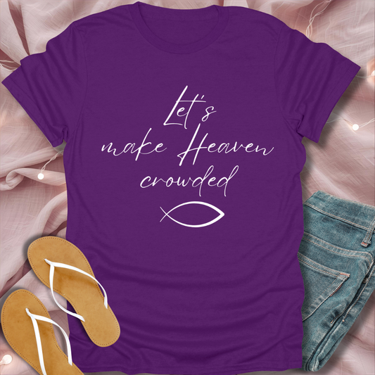 Purple t-shirt with text and fish symbol on a pink fabric background