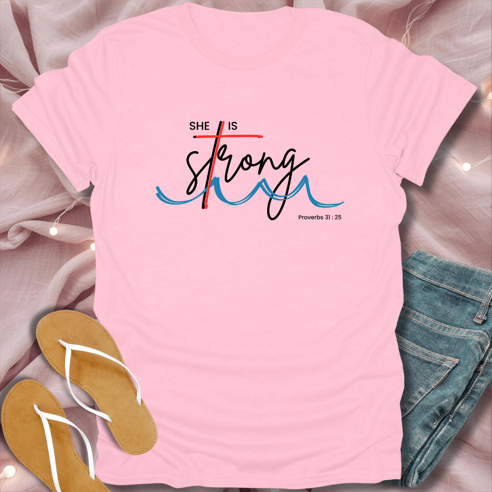 Pink t-shirt with 'She is Strong' text on a light pink background