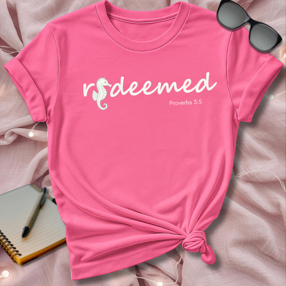 Pink t-shirt with 'redeemed Proverbs 3:5' text on a soft pink background