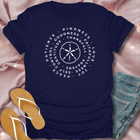 Navy blue t-shirt with motivational text and symbols on a pink fabric background