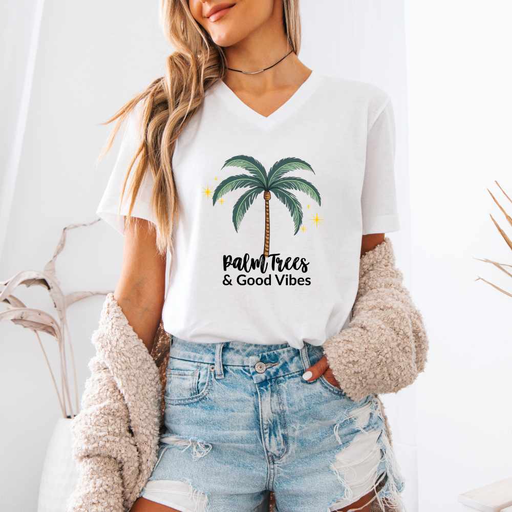 Person wearing a white t-shirt with a palm tree design and 'Palm Trees & Good Vibes' text.