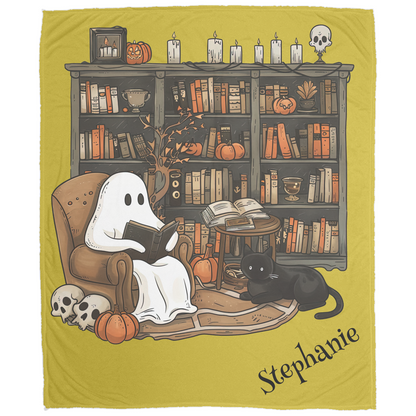 Ghost reading a book with a black cat on a blanket featuring a bookshelf and Halloween decorations.