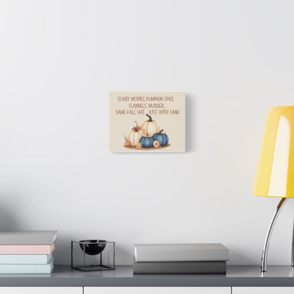 Decorative wall art with pumpkins on a shelf against a white wall.