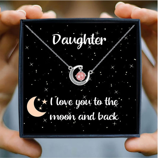 Daughter gift necklace with crescent moon and pink crystal, presented in a starry gift box with the message “I love you to the moon and back.”