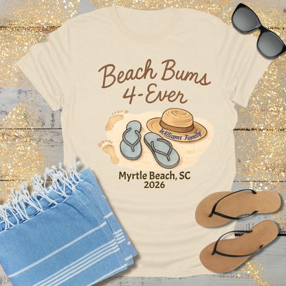 Beach-themed t-shirt with 'Beach Bums 4-Ever' design, sunglasses, towel, and flip-flops on a wooden surface.