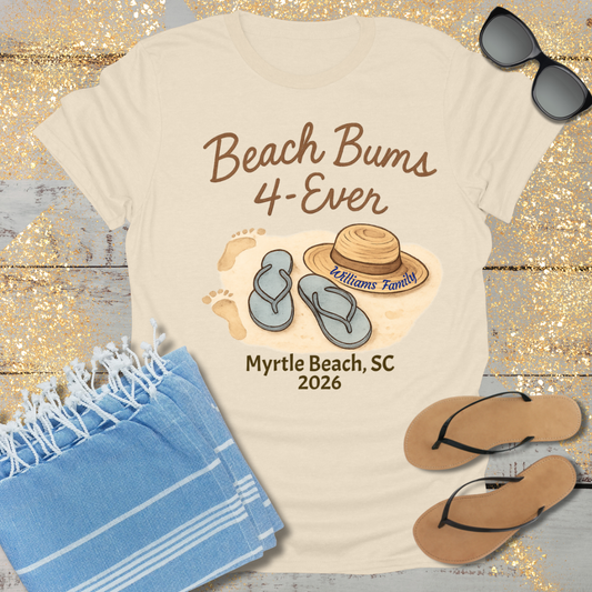 Beach-themed t-shirt with 'Beach Bums 4-Ever' design, sunglasses, towel, and flip-flops on a wooden surface.