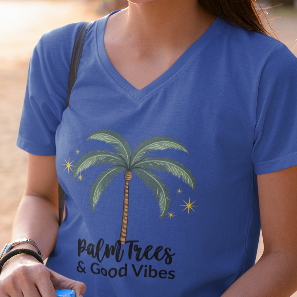 Person wearing a blue t-shirt with a palm tree and 'Palm Trees & Good Vibes' text.
