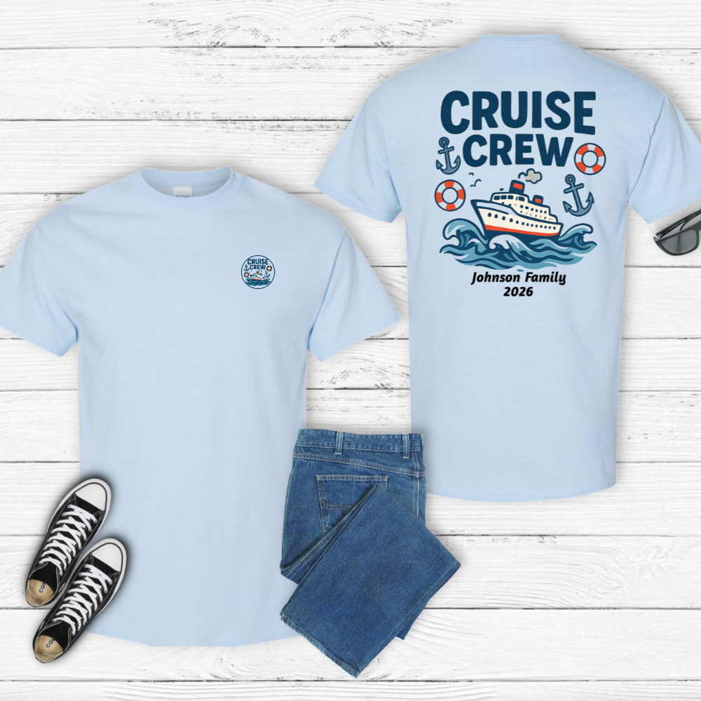 Light blue t-shirt with 'Cruise Crew' design on a wooden surface with jeans and sneakers.