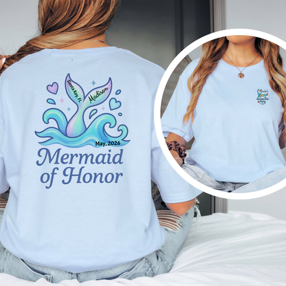 Person wearing a light blue t-shirt with 'Mermaid of Honor' design on the back.