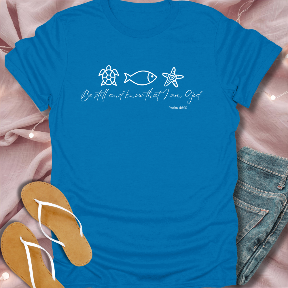 Blue t-shirt with religious text and symbols on a pink fabric background