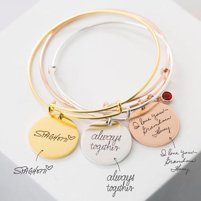 Stylish stackable bangles featuring name discs and gemstone detail