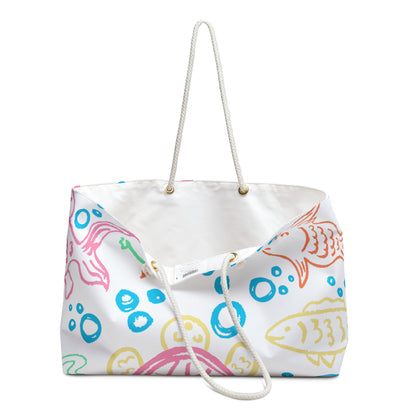 Oversized beach bag with colorful hand-drawn fish and bubbles on white partially open to display the white liner on inside.