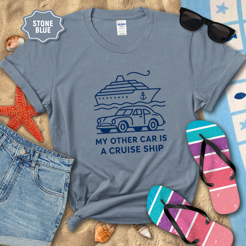 Stone blue t-shirt with a graphic design and text, surrounded by beach accessories.