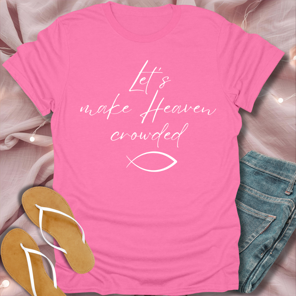Pink t-shirt with text and fish symbol on a soft pink background with flip-flops and jeans.