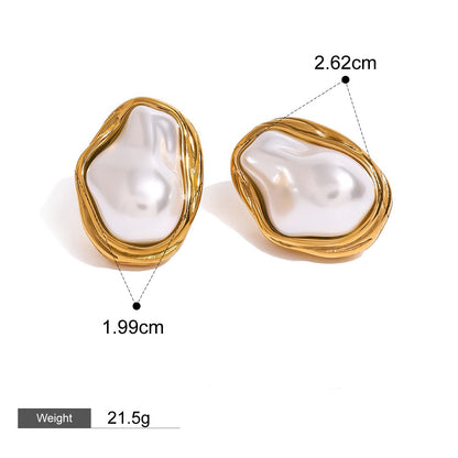 Elegant pearl and gold necklace, ring, and earring trio displayed on beige surface

