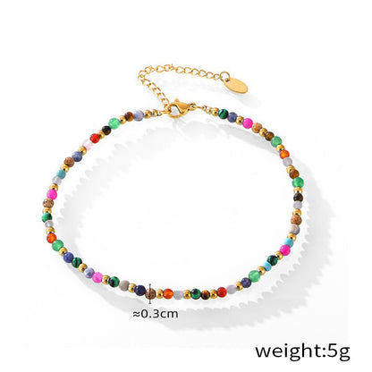 Elegant gold anklets with black gem beads styled on ankle