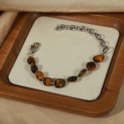 Tiger eye stone bracelet with O-chain links and titanium clasp on display