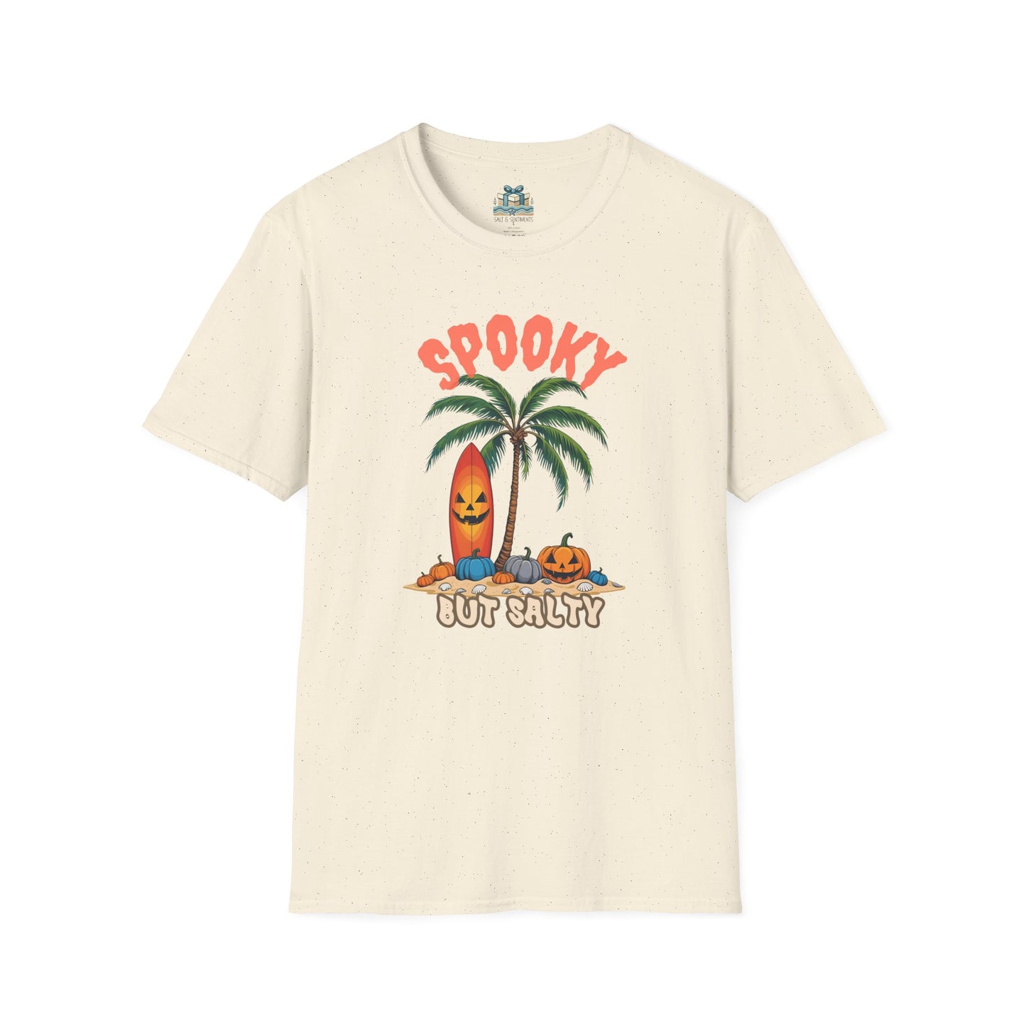 Beige t-shirt with Halloween-themed design featuring a palm tree, surfboard, and pumpkins on a white background.