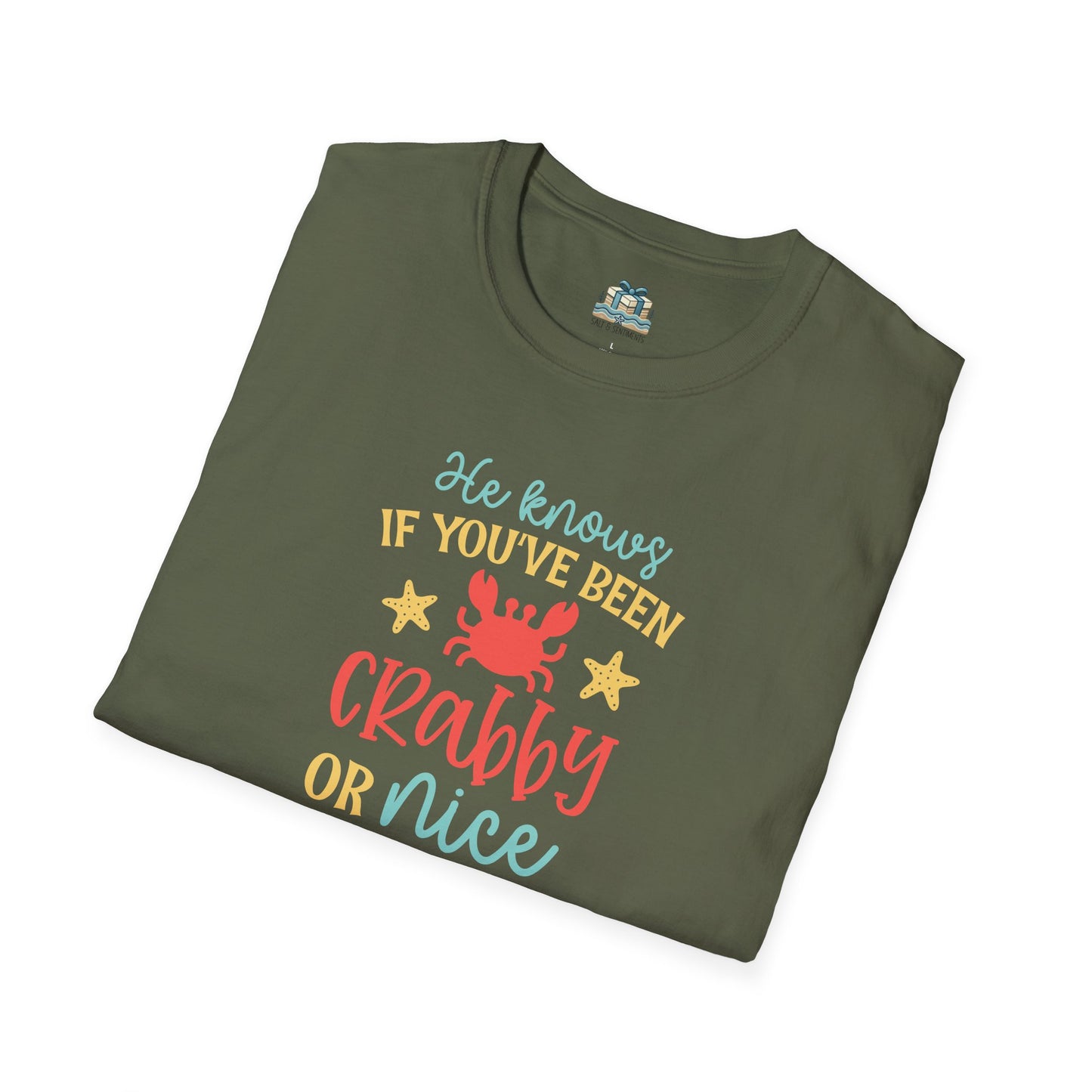 Folded green t-shirt with colorful text and graphics on a white background