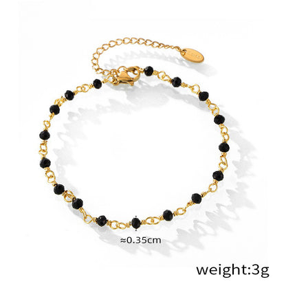 Close-up of dual 18K gold-plated anklets with fine beading detail