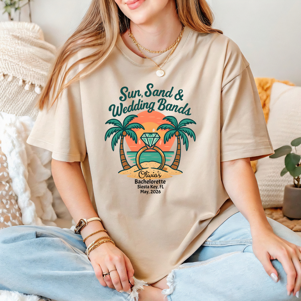 Person wearing a beige t-shirt with a tropical design and text.