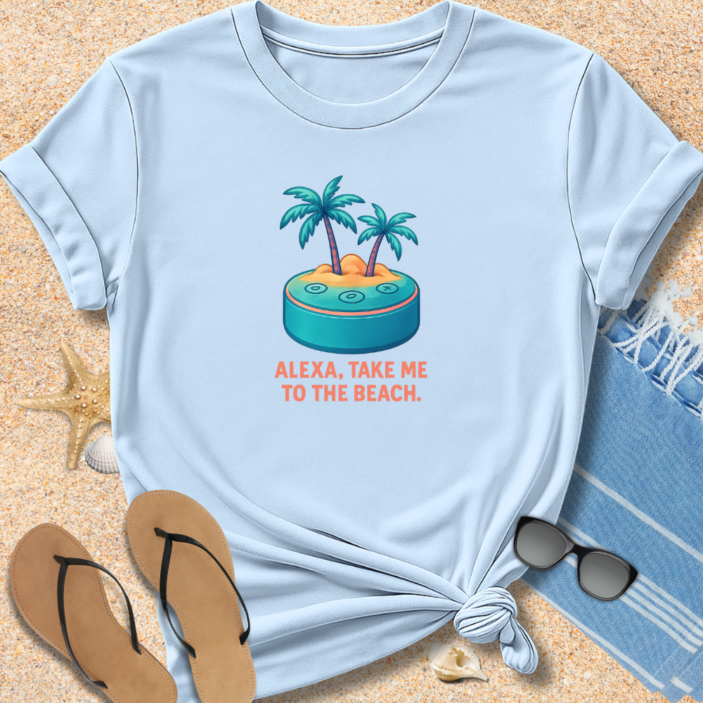 Light blue t-shirt with beach graphic and text 'Alexa, take me to the beach' on sand with flip-flops and towel.