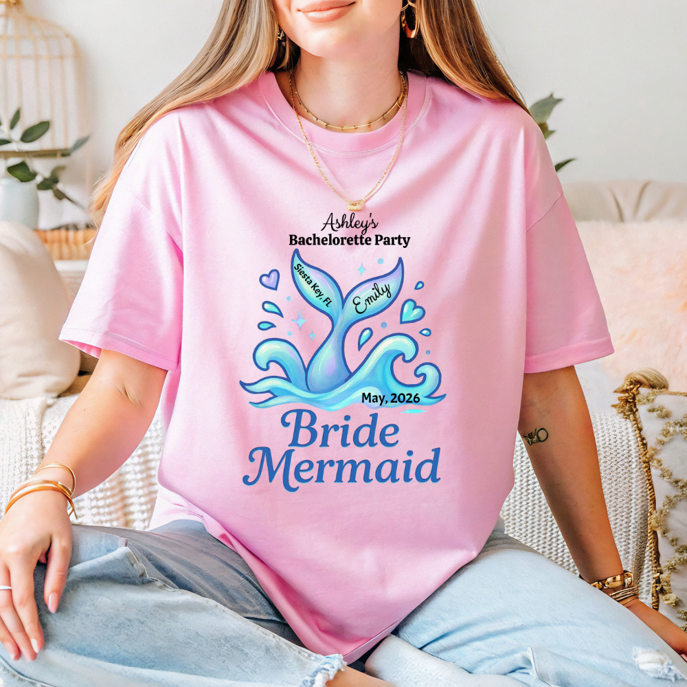 Person wearing a pink t-shirt with 'Bride Mermaid' design and text.