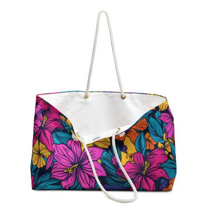 Oversized beach bag with bold tropical floral design in pink, orange, yellow, and teal.  Opening is shown with white liner and rope handles.