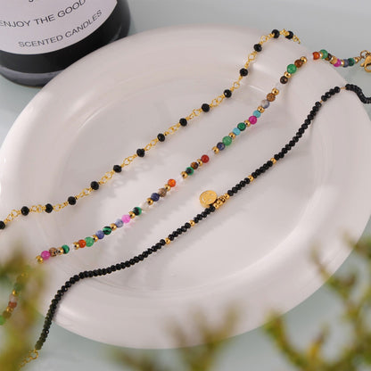 Close-up of dual 18K gold-plated anklets with fine beading detail