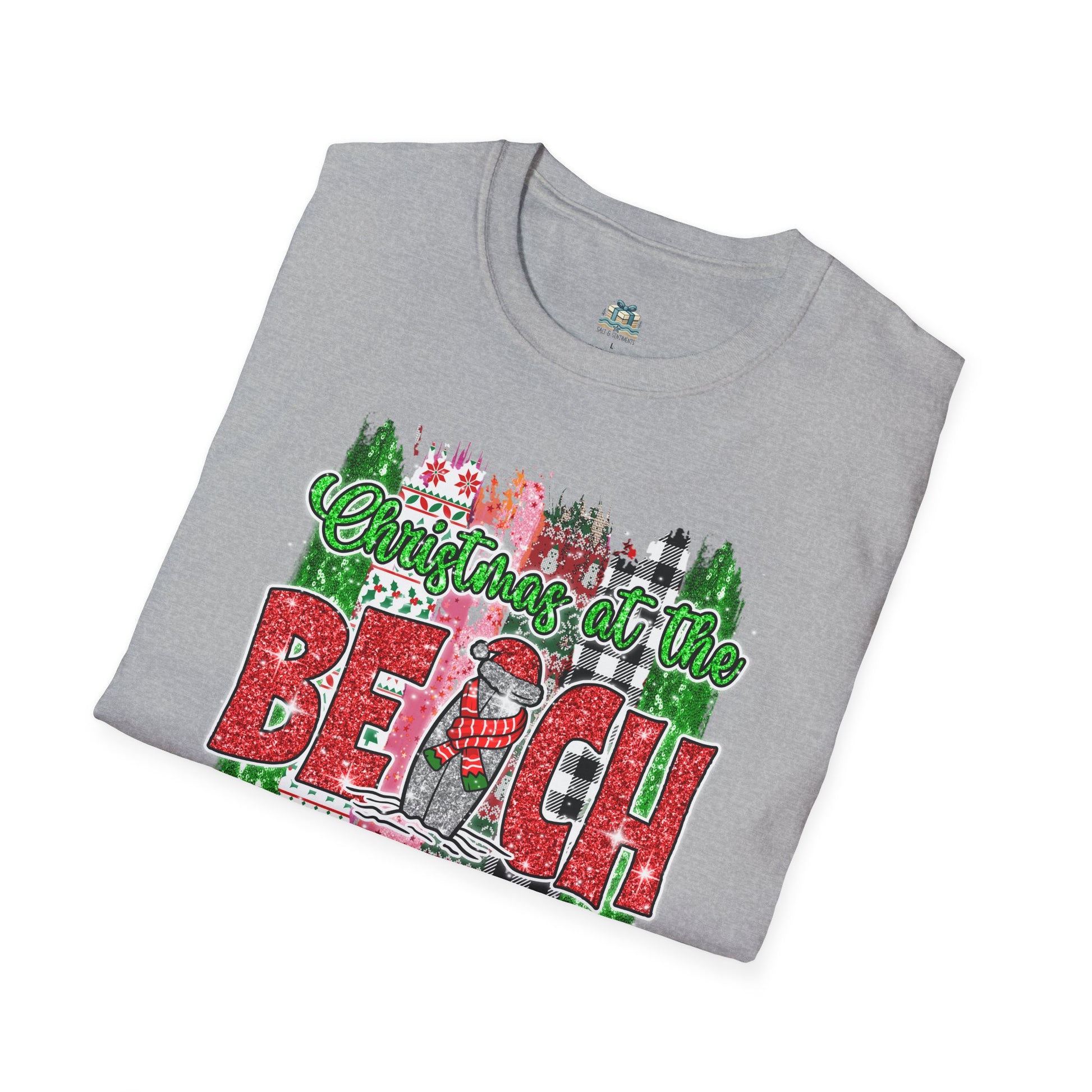 Folded gray t-shirt with 'Christmas at the Beach' graphic design on a white background