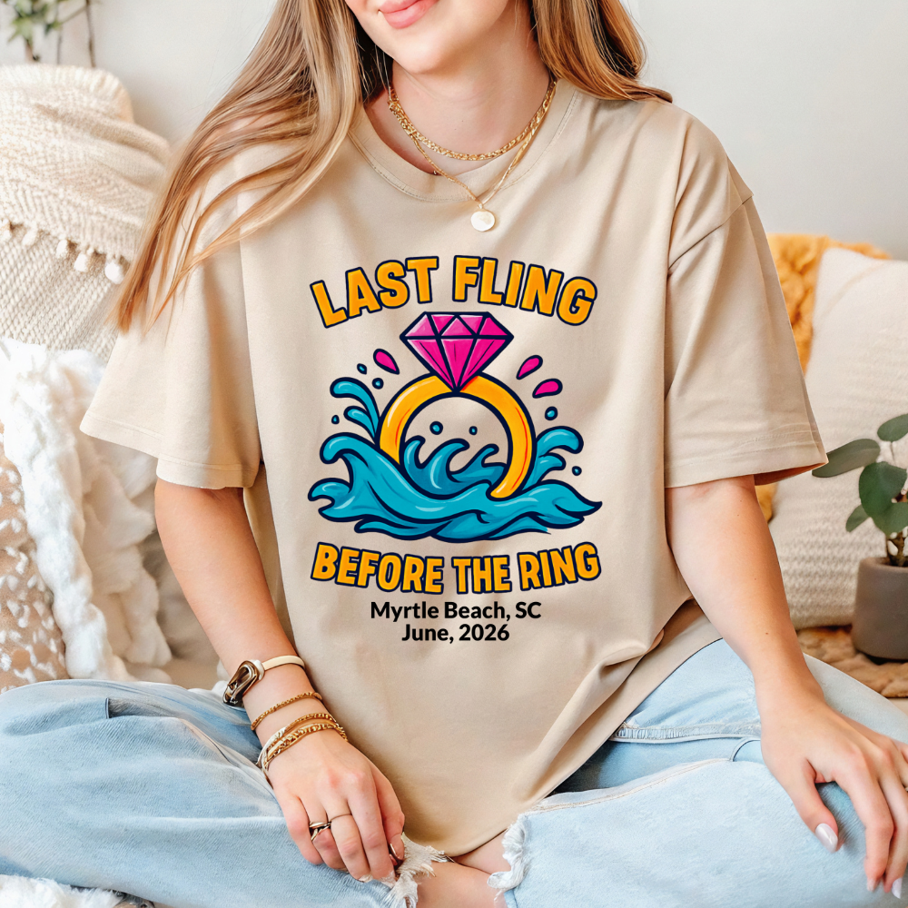 Person wearing a beige t-shirt with a 'Last Fling Before the Ring' design.