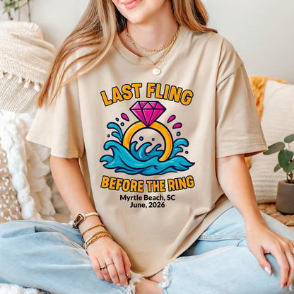 Person wearing a beige t-shirt with a 'Last Fling Before the Ring' design.