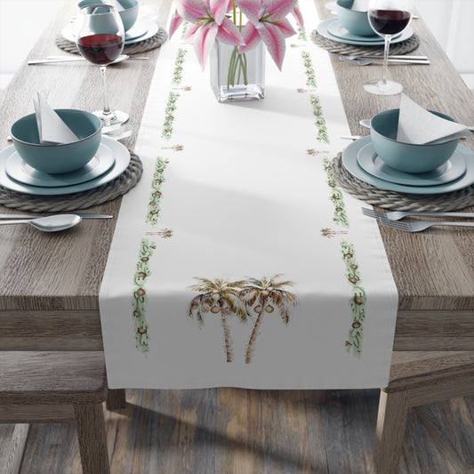 Table setting with a decorative table runner featuring palm trees on a wooden table.