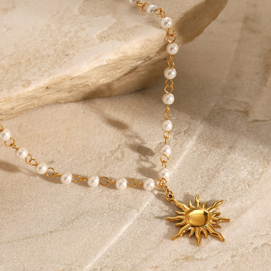 Sun and pearl gold necklace on display

