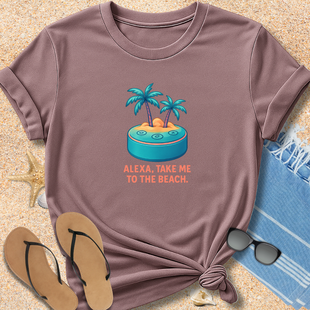 Brown t-shirt with beach graphic and text 'Alexa, take me to the beach' on sand with flip-flops and sunglasses.