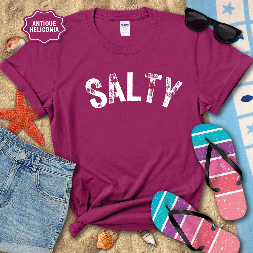 Purple t-shirt with 'SALTY' text on a beach-themed background with sunglasses, flip-flops, and denim shorts.